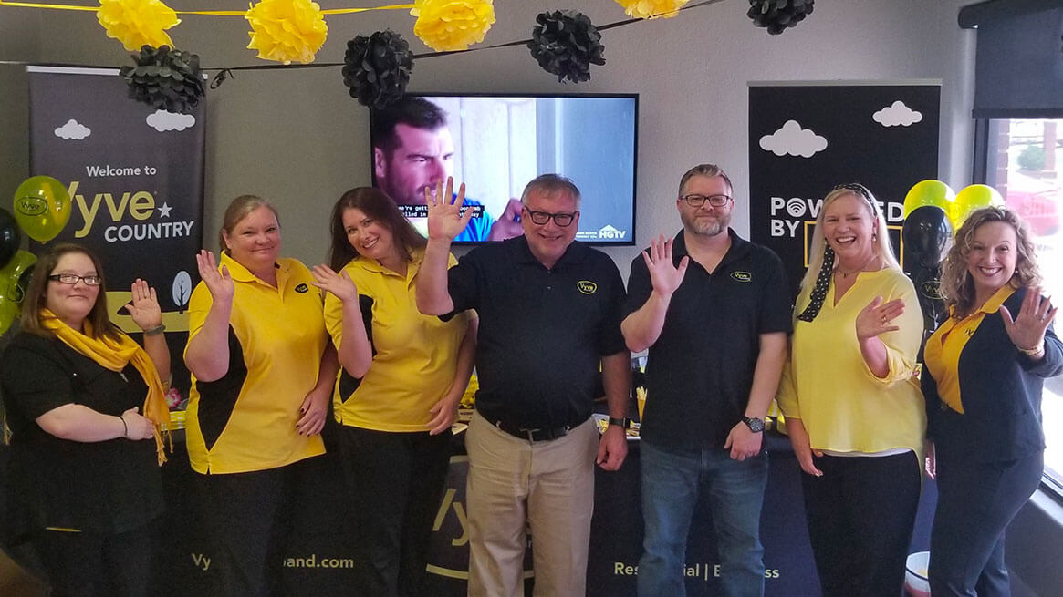 Vyve Texas team showing off their yellow and black